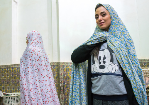 iranian woman with a mickey mouse shirt in the tomb of shah nematollah vali, Kerman province, Mahan, Iran