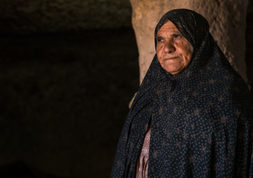 old widow woman inside the mosque of the troglodyte village, Kerman province, Meymand, Iran