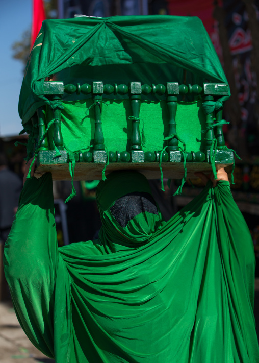 Iranian Shiite Muslim Woman On The Day Of Tasua With Her Face Covered By A Green Veil And Collecting Money In A Craddle, Lorestan Province, Khorramabad, Iran