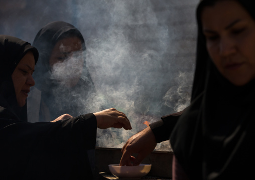 Shia Muslim Women Lighting Incense During Chehel Menbari Festival On Tasua Day For Ashura Celebration, Lorestan Province, Khorramabad, Iran