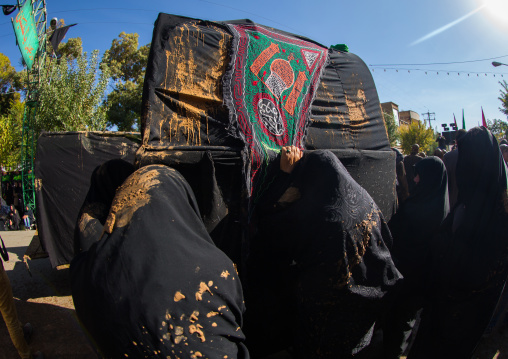 Iranian Shiite Muslim Women Covered In Mud Crying In Front Of A Coffin During Ashura, The Day Of The Death Of Imam Hussein, Kurdistan Province, Bijar, Iran