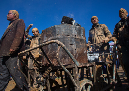 Iranian Shiite Muslim Men Covered In Mud Pushing A Trolley With Fire During Ashura Day, Kurdistan Province, Bijar, Iran