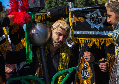 Iranian Shiite Muslim Man Covered In Mud Carrying An Alam During Ashura Day, Kurdistan Province, Bijar, Iran