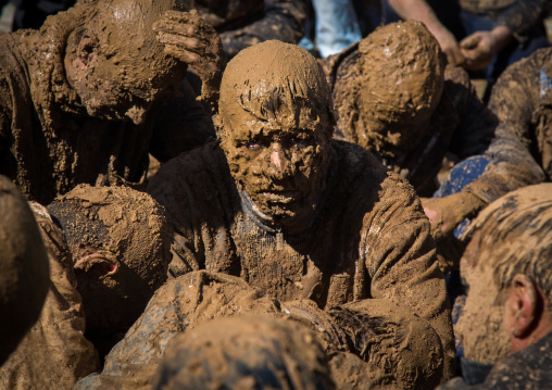 Iranian Shiite Muslim Men Covered In Mud Crying Together During Ashura, The Day Of The Death Of Imam Hussein, Kurdistan Province, Bijar, Iran