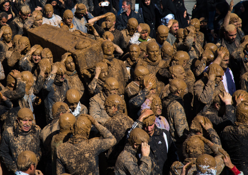 Iranian Shiite Muslim Men Covered In Mud Carrying A Coffin During Ashura, The Day Of The Death Of Imam Hussein, Kurdistan Province, Bijar, Iran