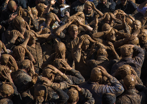 Iranian Shiite Muslim Men Covered In Mud, Chanting And Self-flagellating During Ashura, The Day Of The Death Of Imam Hussein, Kurdistan Province, Bijar, Iran