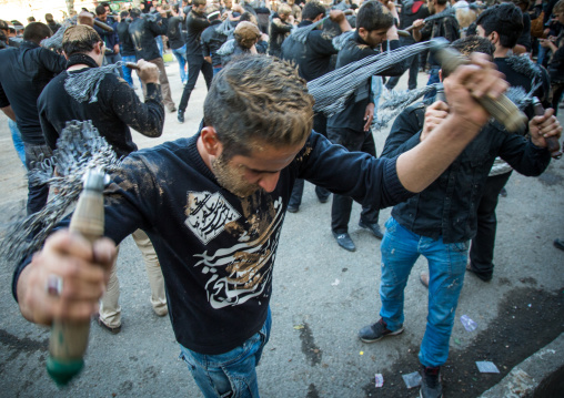 Iranian Shiite Men Covered In Mud Are Beating Themselves With Iron Chains During Ashura, The Day Of The Death Of Imam Hussein, Kurdistan Province, Bijar, Iran