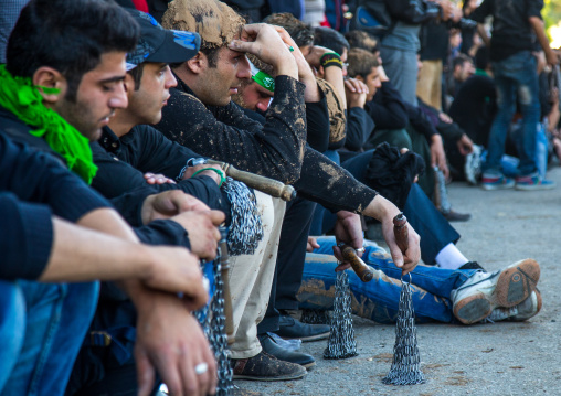 Iranian Shiite Men Covered In Mud With Iron Chains Resting During Ashura, The Day Of The Death Of Imam Hussein, Kurdistan Province, Bijar, Iran