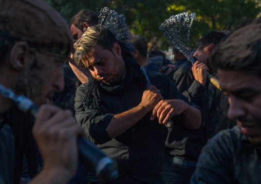 Iranian Shiite Men Covered In Mud Are Beating Themselves With Iron Chains During Ashura, The Day Of The Death Of Imam Hussein, Kurdistan Province, Bijar, Iran