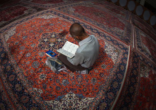 Iranian Shiite Muslim Man Reading The Koran In Fatima Al-masumeh Mosque, Fars Province, Shiraz, Iran