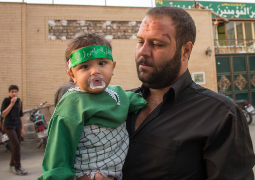 Iranian Shiite Muslim Mourner With Injuries On His Face Caused By Self-flagellation And His Son During Muharram Celebration, Isfahan Province, Kashan, Iran