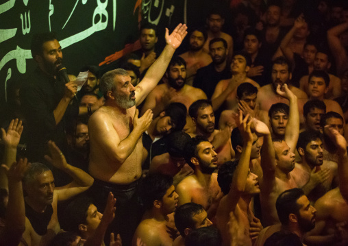 Iranian Shiite Muslim Man Leading Recitations And Songs With The Mad Of Hussein Mourners During Muharram, Isfahan Province, Kashan, Iran