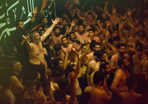 Iranian Shiite Muslim Man Leading Recitations And Songs With The Mad Of Hussein Mourners During Muharram, Isfahan Province, Kashan, Iran