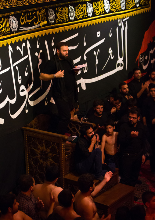 Iranian Shiite Muslim Man Leading Recitations And Songs With The Mad Of Hussein Mourners During Muharram, Isfahan Province, Kashan, Iran