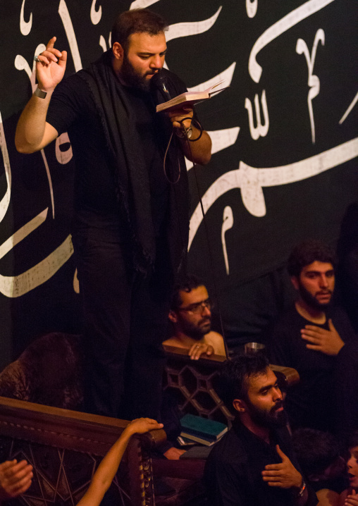 Iranian Shiite Muslim Man Leading Recitations And Songs With The Mad Of Hussein Mourners During Muharram, Isfahan Province, Kashan, Iran