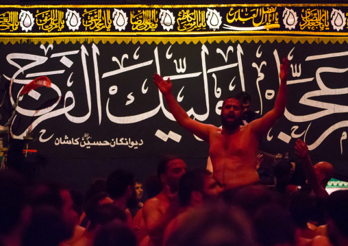 Iranian Shiite Muslim Man Leading Recitations And Songs With The Mad Of Hussein Mourners During Muharram, Isfahan Province, Kashan, Iran