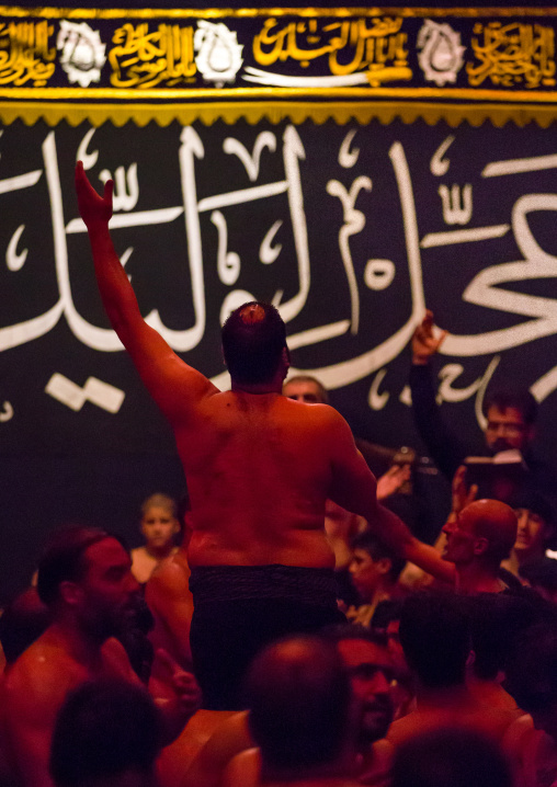 Iranian Shiite Muslim Man Leading Recitations And Songs With The Mad Of Hussein Mourners During Muharram, Isfahan Province, Kashan, Iran