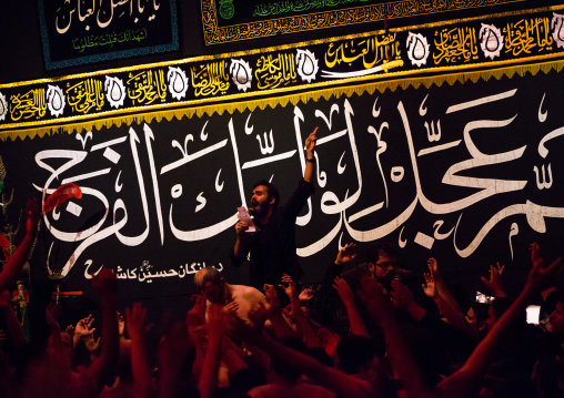 Iranian Shiite Muslim Man Leading Recitations And Songs With The Mad Of Hussein Mourners During Muharram, Isfahan Province, Kashan, Iran