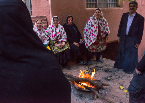 Portrait Of Iranian Women Wearing Traditional Floreal Chadors And Men In Zoroastrian Village, Isfahan Province, Abyaneh, Iran