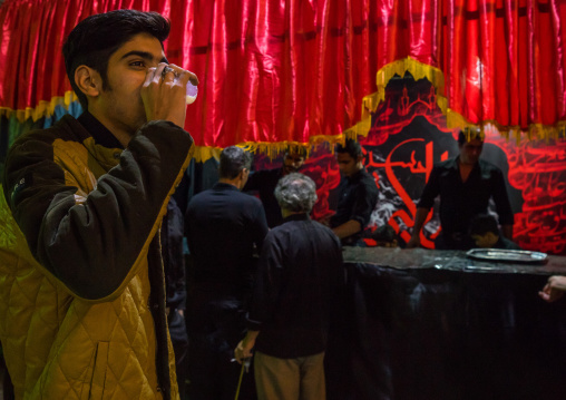 Iranian Shiite Muslim People Drinking Nazri Hot Milk Distributed Freely During Muharram, Isfahan Province, Kashan, Iran