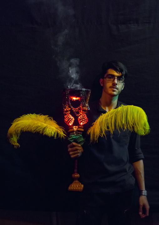 Iranian Shiite Muslim Man Holding An Incense Burner During Ashura, The Day Of The Death Of Imam Hussein, Isfahan Province, Kashan, Iran