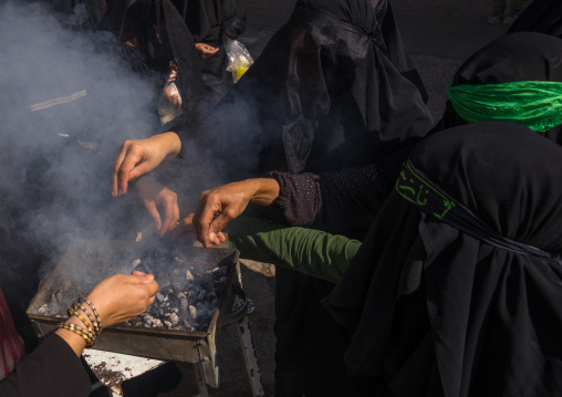 Shia Muslim Women Lighting Incense During Chehel Menbari Festival On Tasua Day For Ashura Celebration, Lorestan Province, Khorramabad, Iran