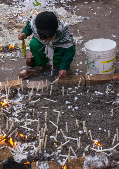 A Boy Lights Candles During Chehel Menbari Festival On Tasu'a Day To Commemorate The Martyrdom Anniversary Of Imam Hussein, Lorestan Province, Khorramabad, Iran