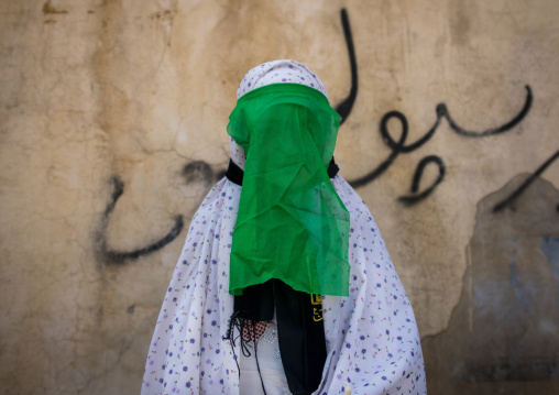 Iranian Shiite Muslim Woman Mourning Imam Hussein On The Day Of Tasua With Her Face Covered By A Green Veil, Lorestan Province, Khorramabad, Iran