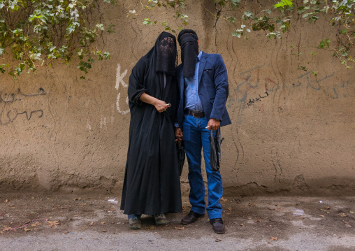 Iranian Shiite Muslim Couple Mourning Imam Hussein On The Day Of Tasua With Their Faces Covered By A Veil, Lorestan Province, Khorramabad, Iran