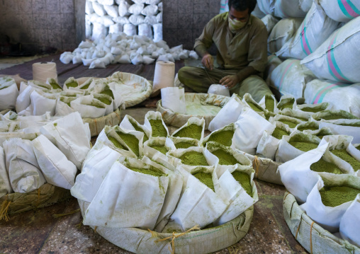 Iranian Worker Packing Henna Bags In A Traditional Mill, Yazd Province, Yazd, Iran