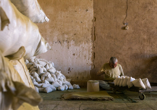 Iranian Worker Packing Henna Bags In A Traditional Mill, Yazd Province, Yazd, Iran