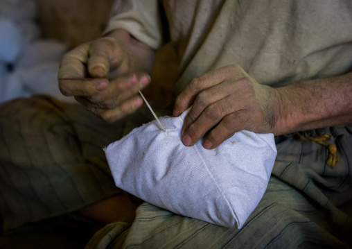 Iranian Worker Packing Henna Bags In A Traditional Mill, Yazd Province, Yazd, Iran