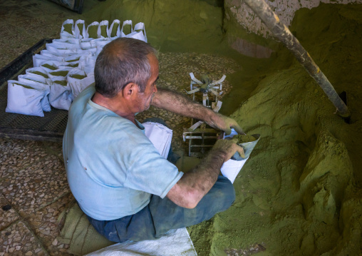 Iranian Worker Packing Henna Bags In A Traditional Mill, Yazd Province, Yazd, Iran