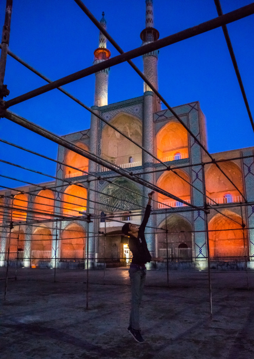 Boy Jumping In Front Of The Three-storey Takieh Part Of The Amir Chakhmaq Complex, Yazd Province, Yazd, Iran