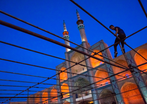 Man Sitting On A Scaffolding In Front Of The Three-storey Takieh Part Of The Amir Chakhmaq Complex, Yazd Province, Yazd, Iran