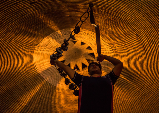 Iranian Man Training With Kabbadeh Chain And Bow At Saheb A Zaman Club Zurkhaneh, Yazd Province, Yazd, Iran