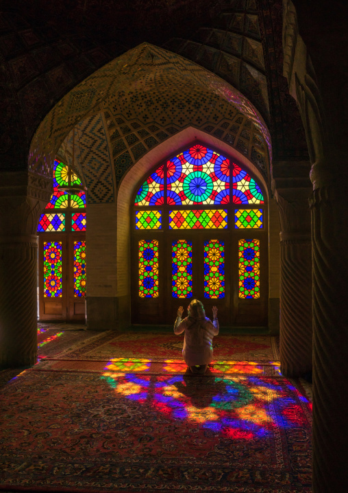 Iranian Woman Praying In The Nasir Ol Molk Mosque With Its Beautiful Coloured Glass Windows, Fars Province, Shiraz, Iran