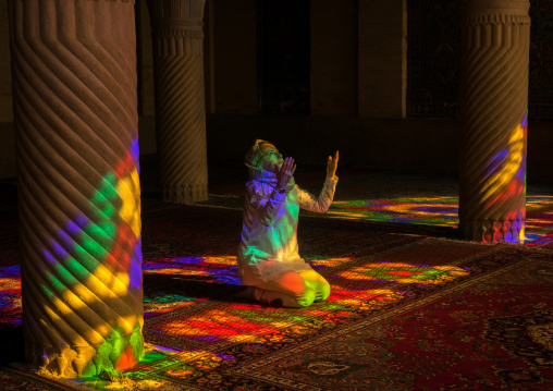 Iranian Woman Praying In The Nasir Ol Molk Mosque With Its Beautiful Coloured Glass Windows, Fars Province, Shiraz, Iran