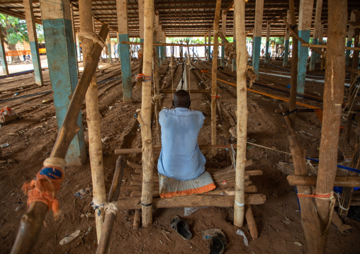 African man weaving in a traditional textile factory, Savanes district, Waraniene, Ivory Coast