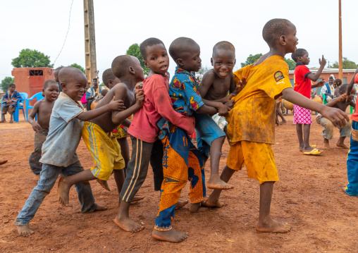 African children dancing in line during the Boloye dance of the panther man, Savanes district, Waraniene, Ivory Coast