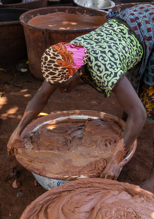 Senufo woman prepairing shea butter in a traditional karité factory, Savanes district, Tcheregnimin, Ivory Coast