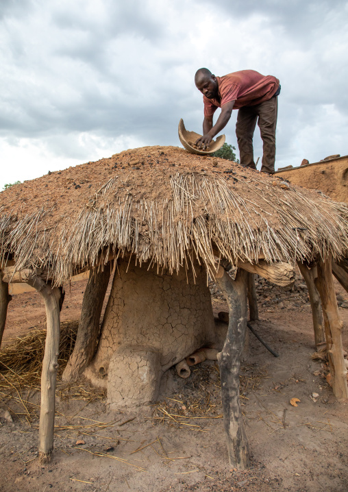 Senufo blacksmith putting charcoal from the top of the house, Poro region, Koni, Ivory Coast