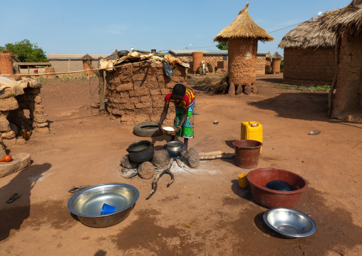 African woman preparing food in the house courtyard, Savanes district, Niofoin, Ivory Coast