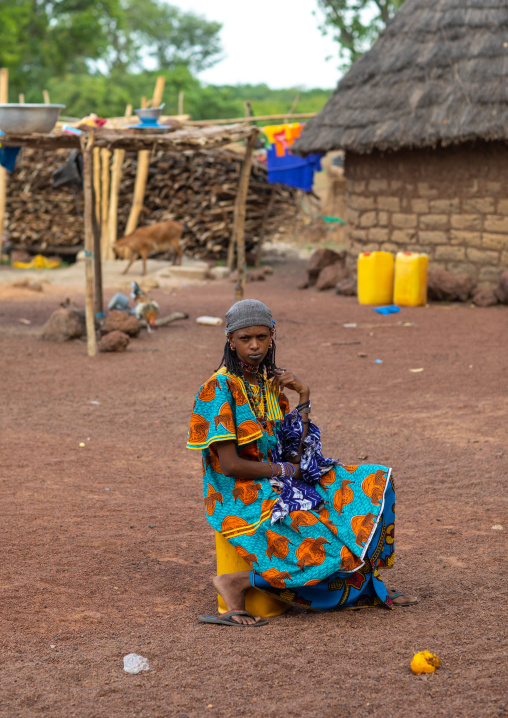 Peul tribe girls sit in the middle of a village, Savanes district, Boundiali, Ivory Coast