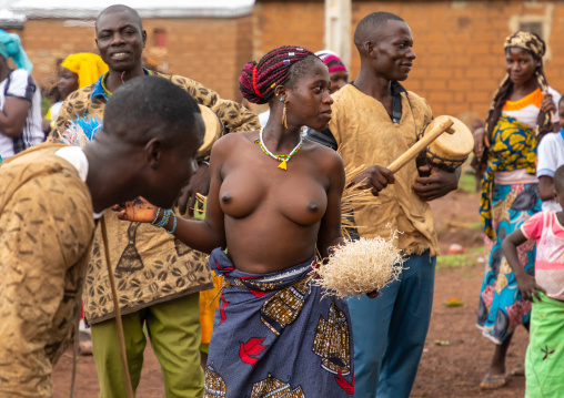 Young Senufo shirtless woman dancing the Ngoro during a ceremony, Savanes district, Ndara, Ivory Coast