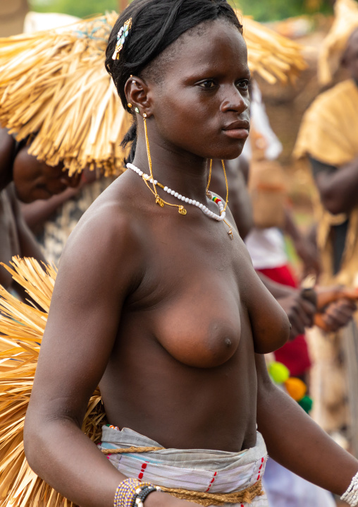 Young Senufo shirtless woman dancing the Ngoro during a ceremony, Savanes district, Ndara, Ivory Coast