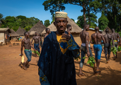 Dan tribe men dancing with leaves during a ceremony, Bafing, Gboni, Ivory Coast