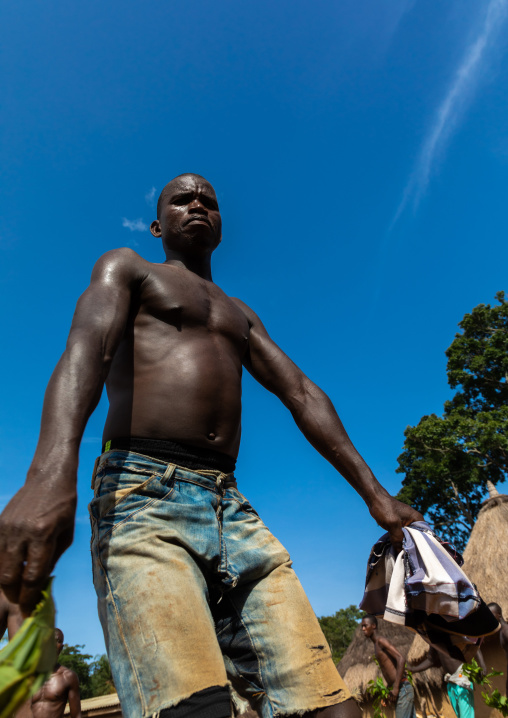 Dan tribe man dancing with leaves during a ceremony, Bafing, Gboni, Ivory Coast