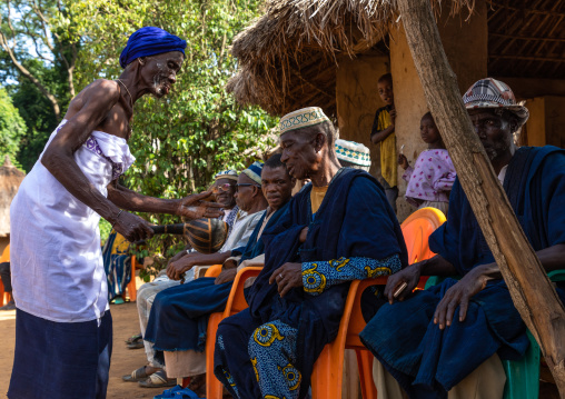 Senior Dan tribe woman begging for money to the chiefs during a ceremony, Bafing, Gboni, Ivory Coast