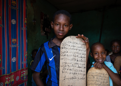 Children with wood boards for writing koran in a koranic school, Tonkpi Region, Man, Ivory Coast